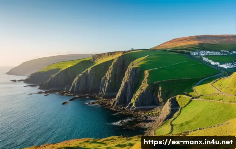 맨섬 경제 구조 - A panoramic view of the Isle of Man&rsquo;s rugged coastline during golden hour, featuring lush green hill...